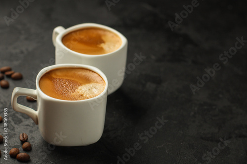 coffee fresh and hot in a white cup, aroma. serving of beverage (coffee grain). food. top view. copy space