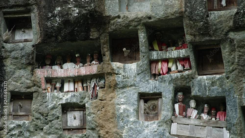 Famous funeral of Tana Toraja.Typical Toraja tombs in a vertical rock ...