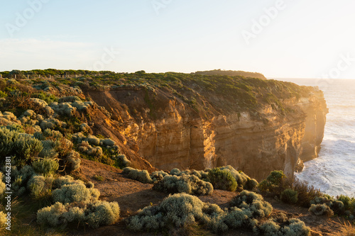 Rock cliff with sunset light facing towards the ocean.