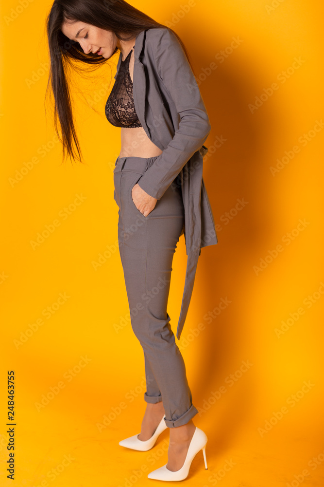 beautiful and sexy woman wearing a gray suit with a stylish women's jackets  and pants. Conception of business woman, student, young business lady.  Stock Photo | Adobe Stock