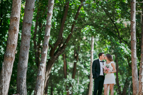 Happy couple walks in the park enjoying tender moments. © CRISTINA