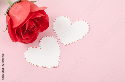 Blank card heart shape with red rose on pink background. © gamjai
