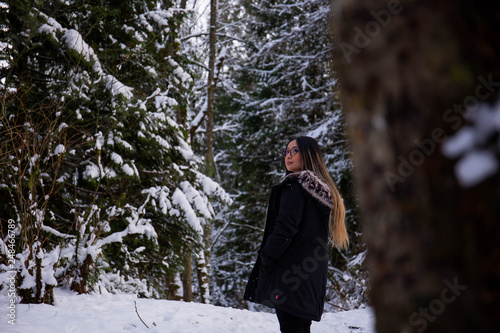young woman in winter forest