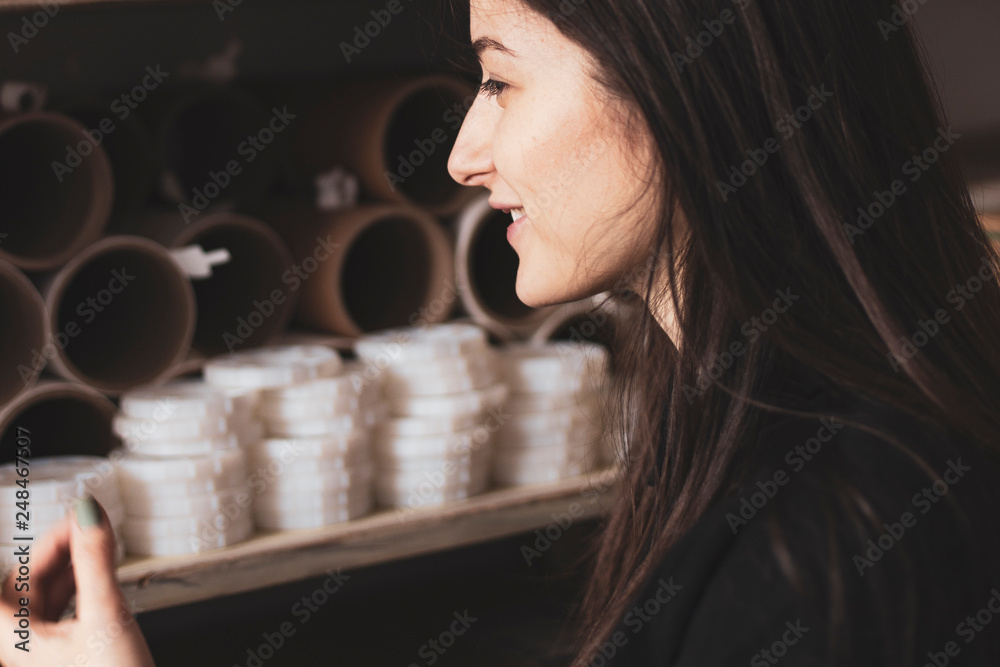 young pretty girl, student, hipster, doing a startup, working in an office or library, browsing dusty shelves with cardboard boxes in typography young pretty girl, student, hipster, doing a startup, working in an office or library, browsing dusty shelves with cardboard boxes in typography