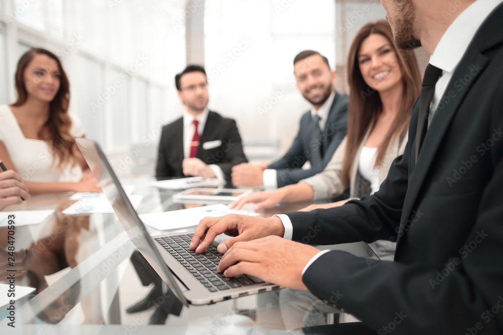 Businessman using laptop during a meeting of the Board of Directors Businessman using laptop during a meeting of the Board of Directors