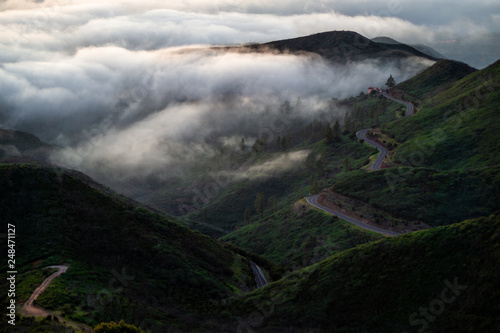 road in the mountains over the clouds
