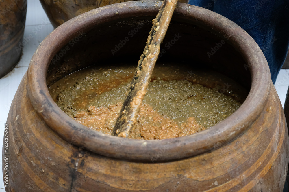 Fototapeta premium salted soybean paste in jar. soy miso production