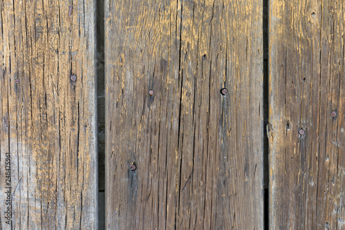 Old weathered wooden boards painted yellow paint. For background and design.