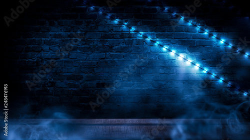 Illumination of an empty brick wall  neon light  smoke. The night scene of an empty room is decorated with abstract light. Night smoke.