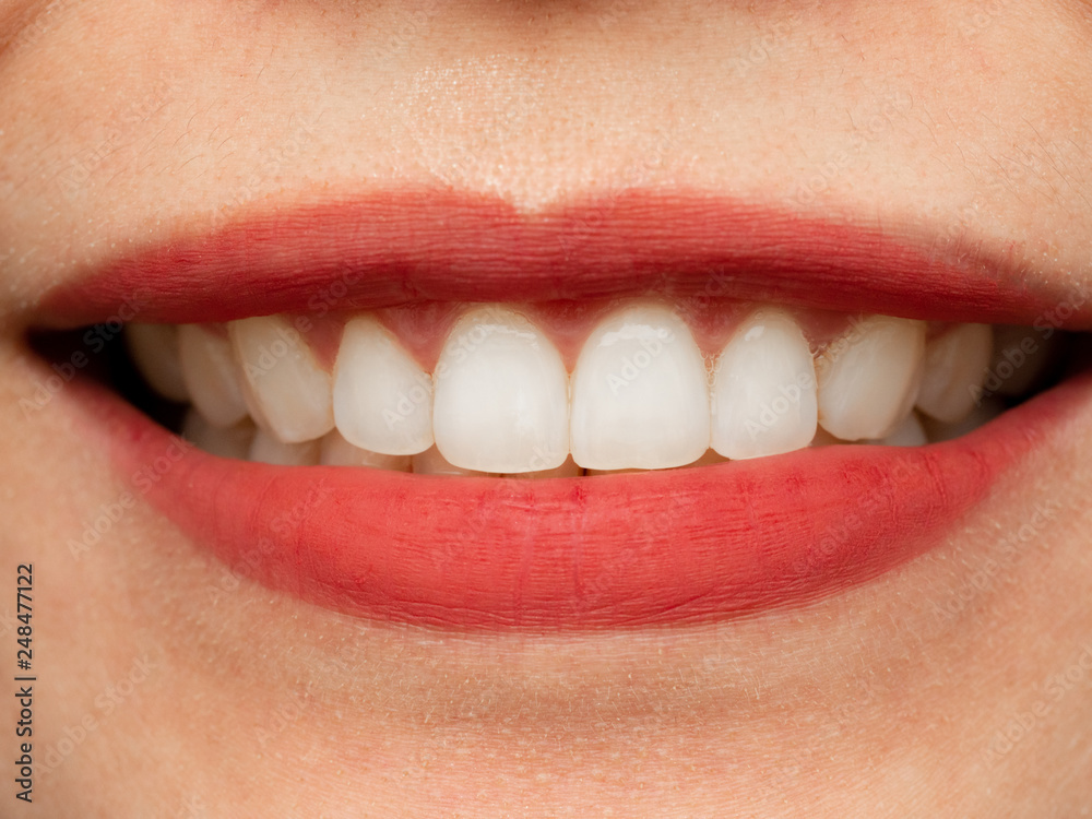 Obraz premium Closeup shot of human Asian Chinese Thai woman female makeup face. Woman with red lips lipstick and healthy dental white great perfect teeth. Smiling, Dental dentist clinic concept.