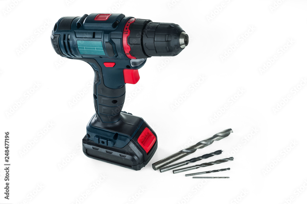 Cordless drill and a set of different drills. Isolated on white background.. Cordless drill and a set of different drills. Isolated on white background..