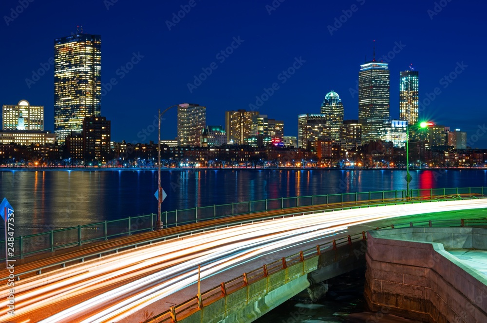 Fototapeta premium Long exposure of Boston skyline at night with charles river and memorial drive