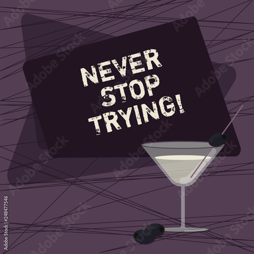 Conceptual hand writing showing Never Stop Trying. Business photo showcasing fight hardest battle inorder reach your goals and dreams Filled Cocktail Wine Glass with Olive on the Rim Text Space photo
