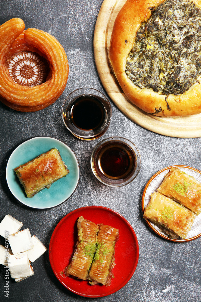 Middle eastern or arabic dishes and assorted meze, concrete rustic background. sambusak. Turkish Dessert Baklava with pistachio. Halal food. Middle eastern or arabic dishes and assorted meze, concrete rustic background. sambusak. Turkish Dessert Baklava with pistachio. Halal food.