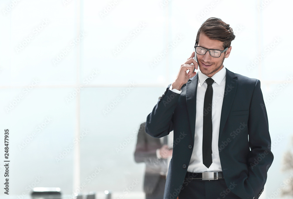 confident businessman talking on a mobile phone. confident businessman talking on a mobile phone.