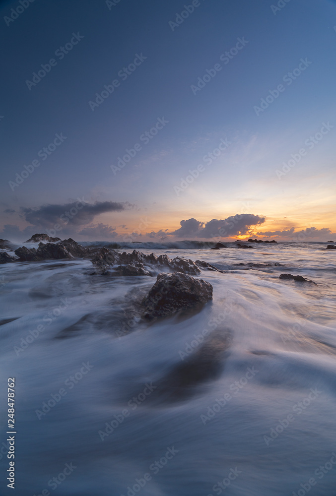 Waves motion of beach at east coast, Terengganu, Malaysia with dramatic clouds and sky during sunrise or sunset