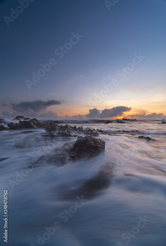 Waves motion of beach at east coast, Terengganu, Malaysia with dramatic clouds and sky during sunrise or sunset