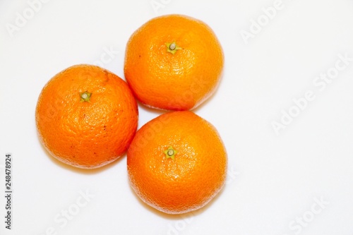 Three mandarins isolated on white background and space for your text.