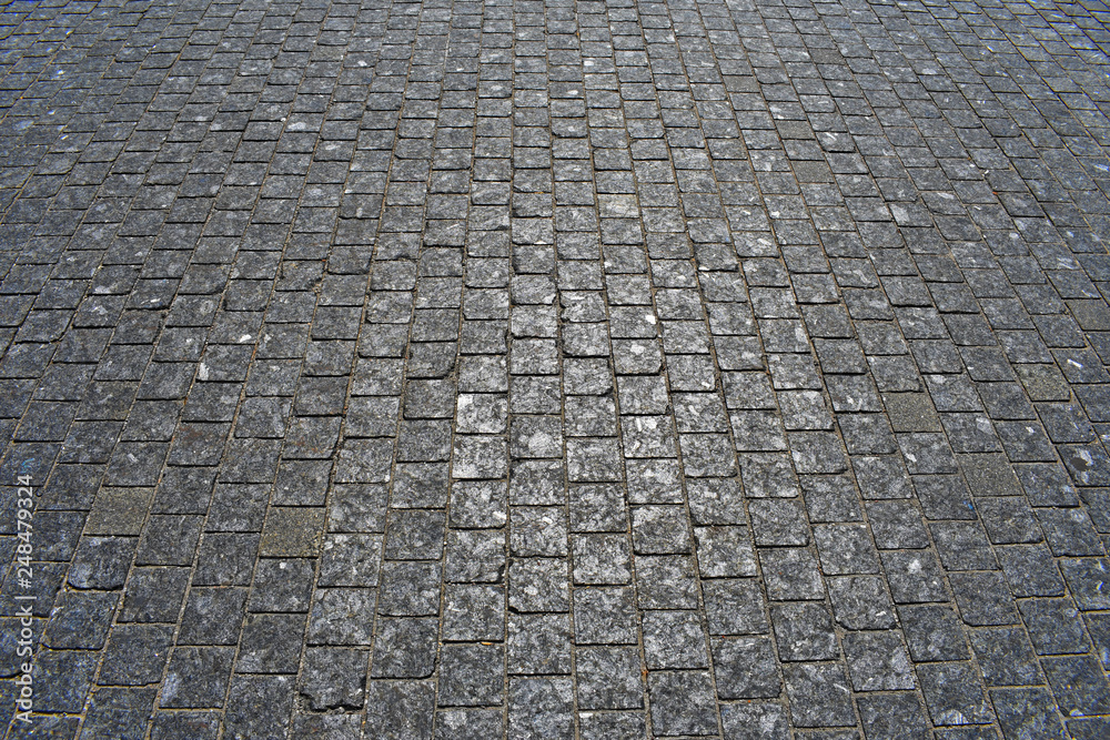pavement of dark gray cobblestone in perspective