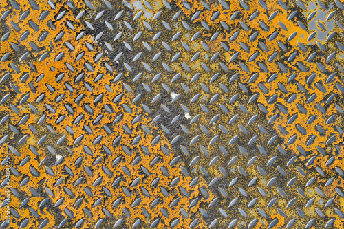 corrugated iron sheet with traces of yellow paint, seamless texture