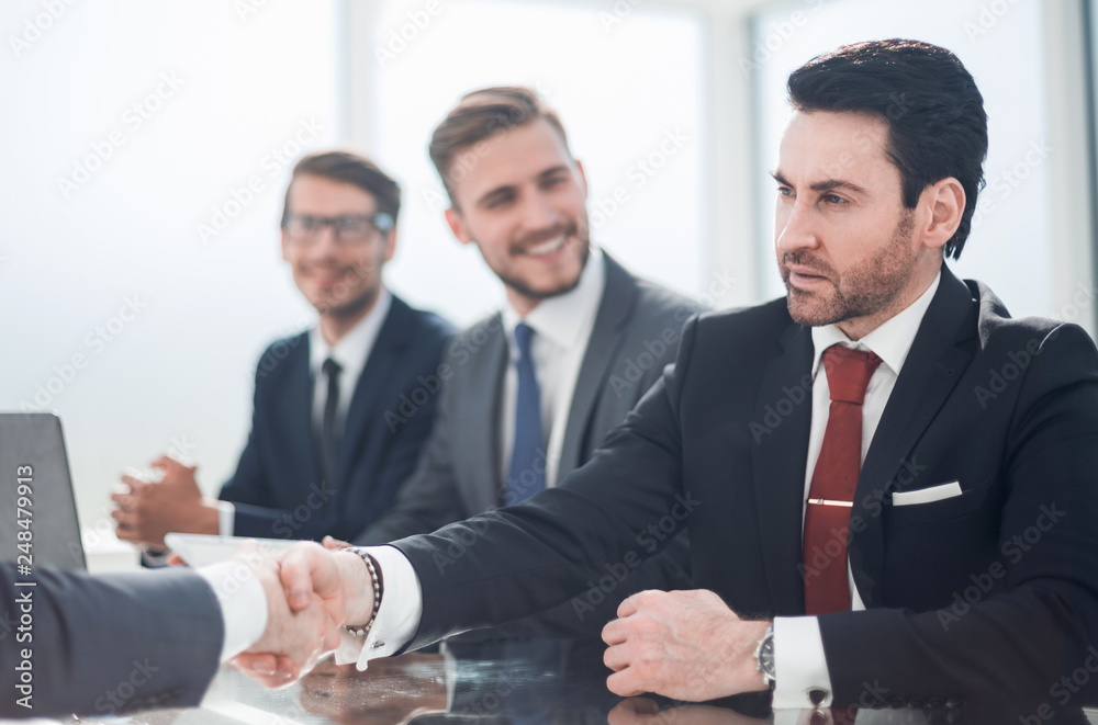 handshake business people sitting at the office Desk handshake business people sitting at the office Desk