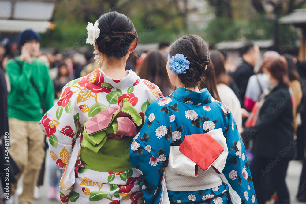 Young girl wearing Japanese kimono standing in front of Sensoji Temple in Tokyo, Japan. Kimono is a Japanese traditional garment. The word Young girl wearing Japanese kimono standing in front of Sensoji Temple in Tokyo, Japan. Kimono is a Japanese traditional garment. The word