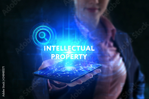 The concept of business, technology, the Internet and the network. A young entrepreneur working on a virtual screen of the future and sees the inscription: Intellectual property