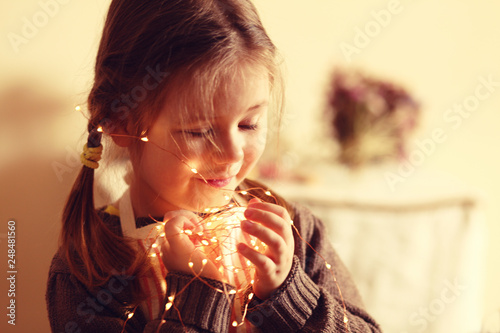 little girl holding the light garland birthday mother s day concept