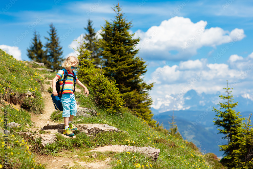 Children hiking in Alps mountains. Kids outdoor.