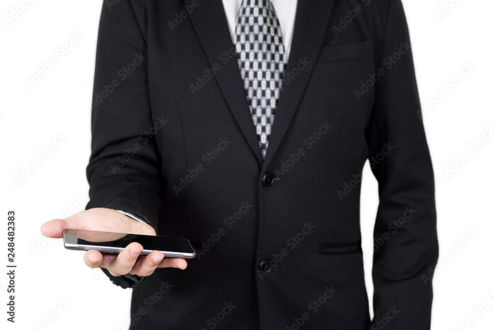 Businessman in Black Suit and Tie Holding Smartphone in Hand Against White Background Businessman in Black Suit and Tie Holding Smartphone in Hand Against White Background