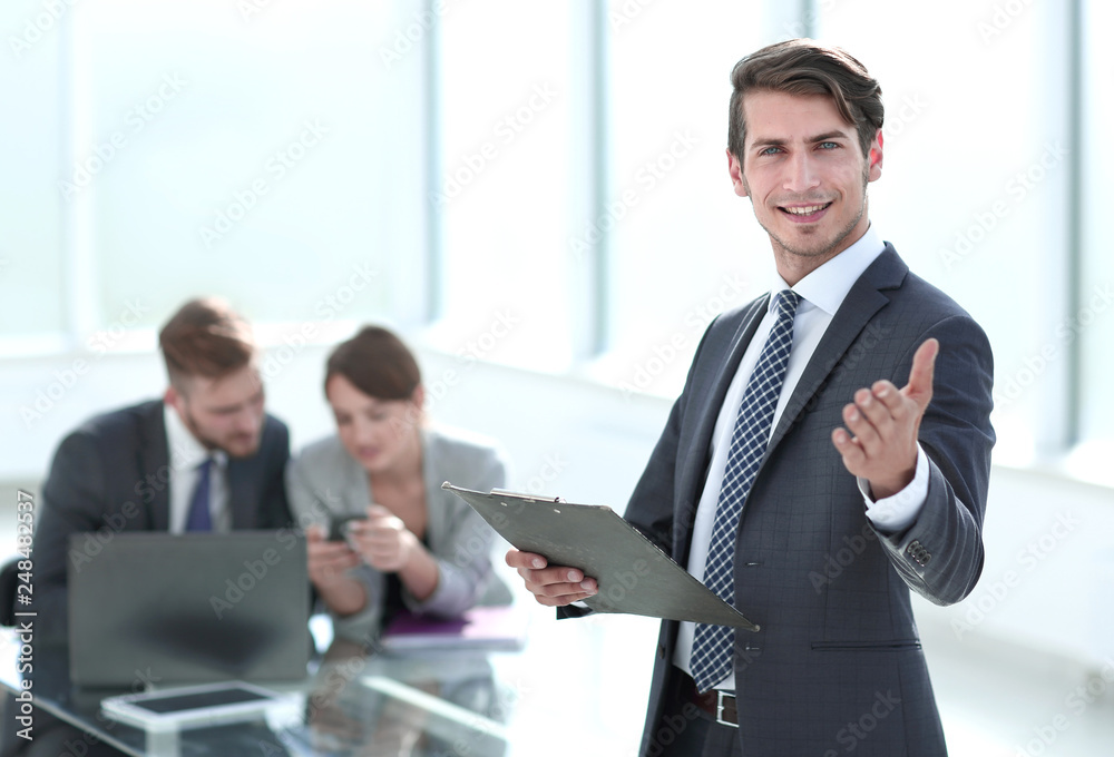 confident young businessman standing in the office. confident young businessman standing in the office.