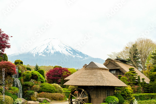 Oshino Hakkai, Close up Japanese historic thatch roof farmhouses with Mt. Fuji background, a small village in autumn ,Japan. photo