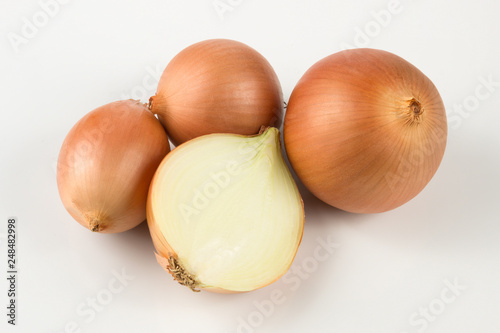 heap of fresh beige onion bulb on white background