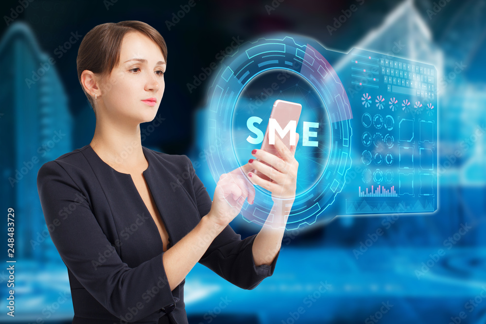 The concept of business, technology, the Internet and the network. A young entrepreneur working on a virtual screen of the future and sees the inscription: SME The concept of business, technology, the Internet and the network. A young entrepreneur working on a virtual screen of the future and sees the inscription: SME
