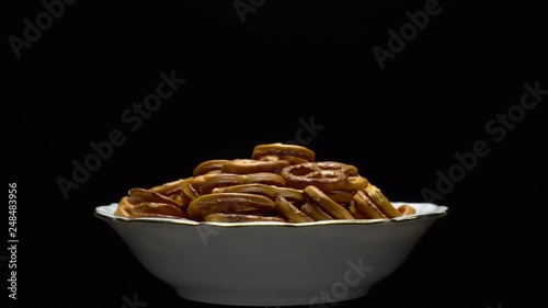 Pretzel salted in rotation. Close up. Studio shot. Black background. Unhealthy diet concept. Junk food concept.