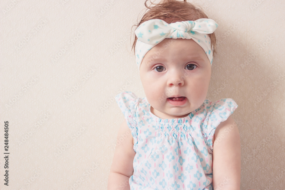 Portrait of eight month girl in the dress with headband, indoors Portrait of eight month girl in the dress with headband, indoors