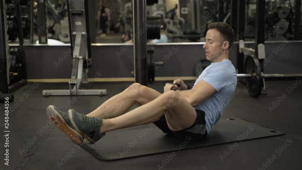 Image of a muscular man using kettlebell in exercise at the gym. Image of a muscular man using kettlebell in exercise at the gym.