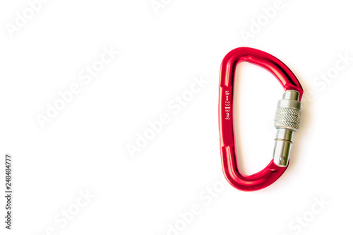Red locking karabiner done up, isolated on white background, with copy space. Close up of locking carabiner. Basic climbing gear.