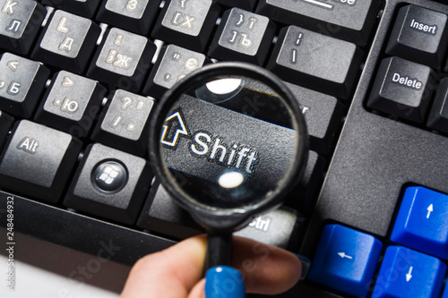 The black keyboard from the computer with a magnifying glass. Keys enter and shift. Tool. Press. Typing.