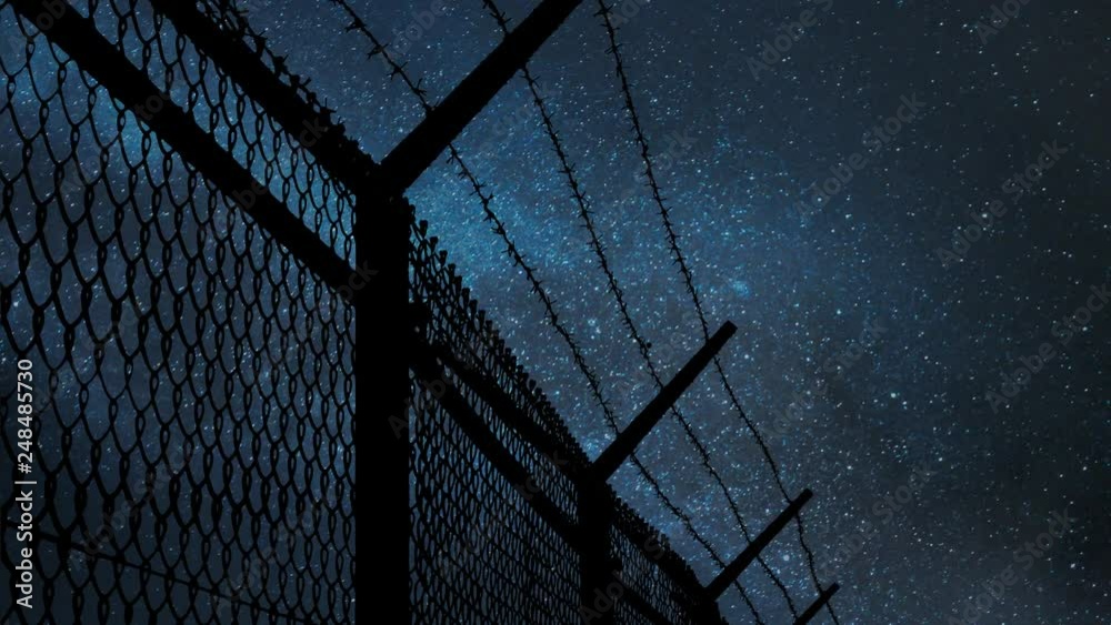 Wired Fence with Barbed Wire and Mesh Steel Wall by Night with Stars ...