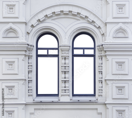 Close up view on a facade of white ancient building with two-part isolated arched windows (mock up)
