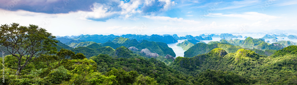 scenic view over Ha Long bay from Cat Ba island, Ha Long city in the background, UNESCO world heritage site, Vietnam