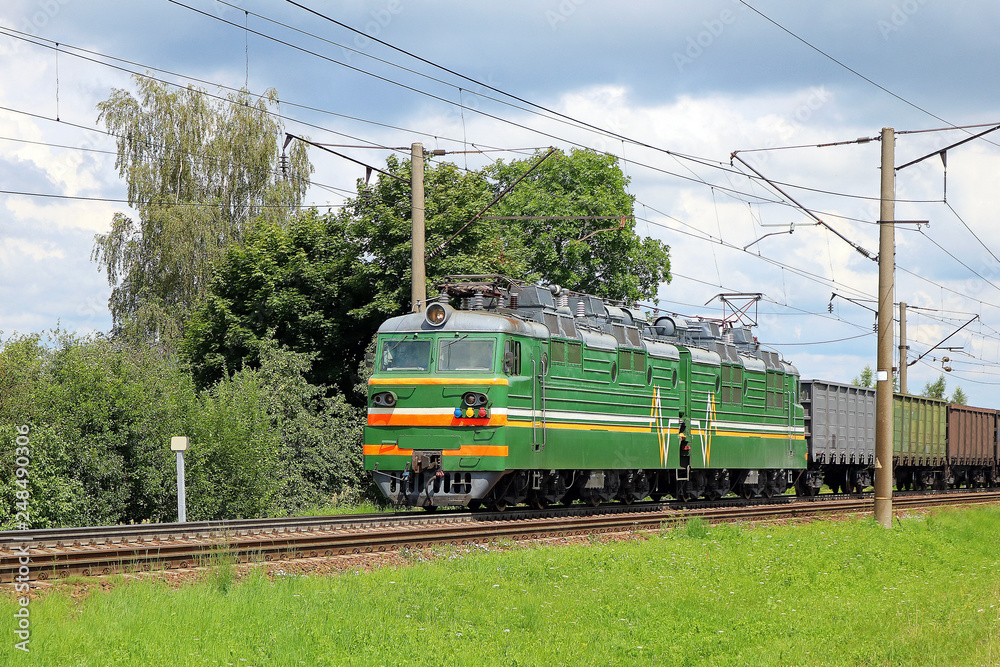 Naklejka premium electric locomotive with freight train