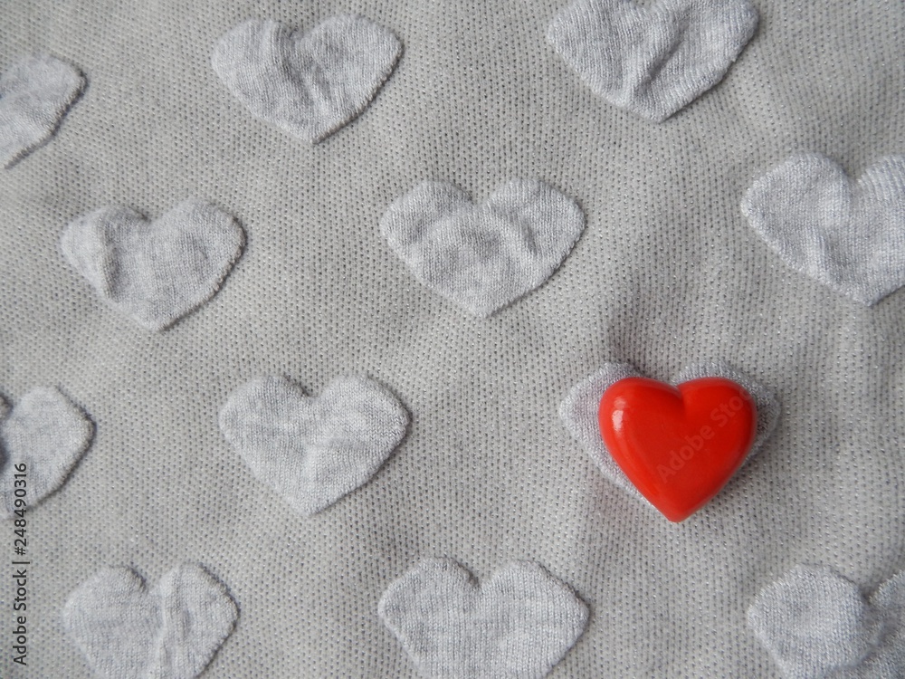 Grey heart shaped knitwear texture with red heart