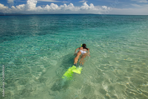Young woman snorkeling in clear shallow water