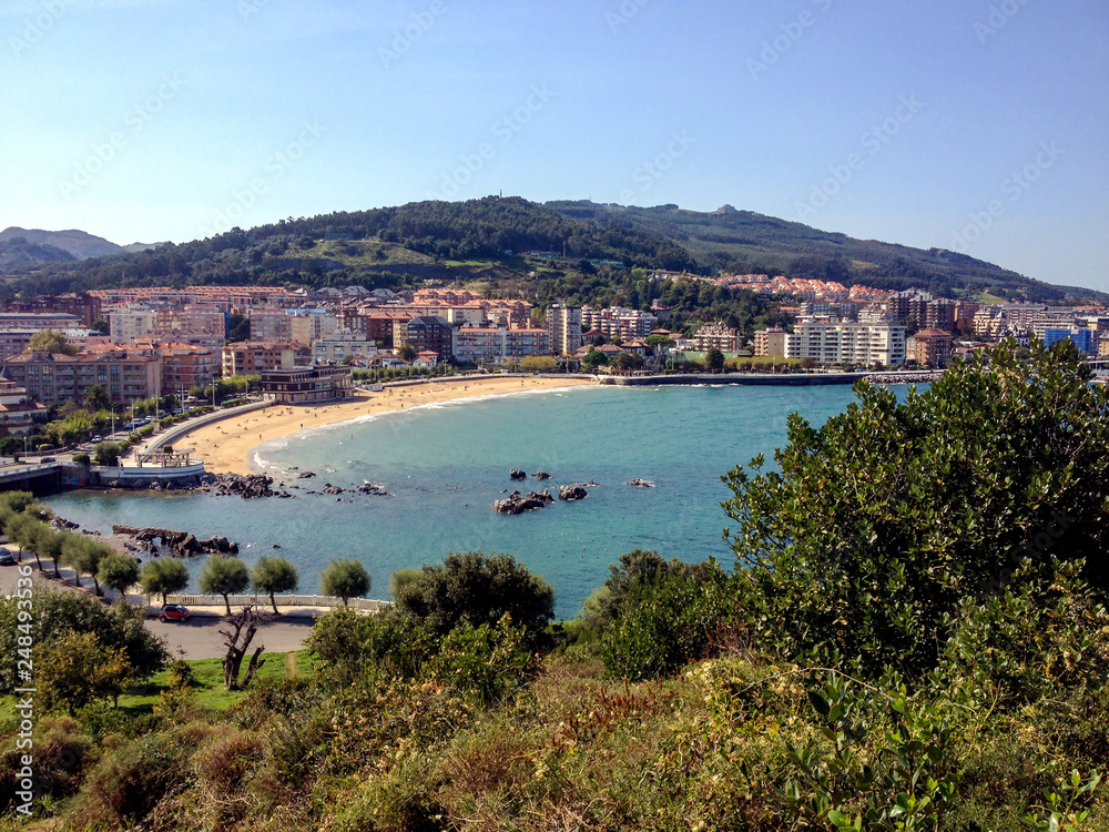 Panorama of Castro Urdiales with sandy beach and blue Cantabrian sea water, Northern coast of Spain
