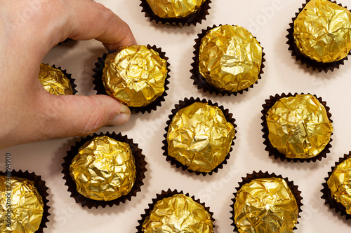 woman eat a golden premium chocolate sweets