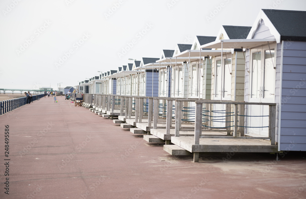 brighton, england, 05/05/2018 Beautiful retro vintage wooden seaside huts on a promenade on the coast. Sunny beach traditional holidays with a neutral pastel colour. Wooden seaside buildings.