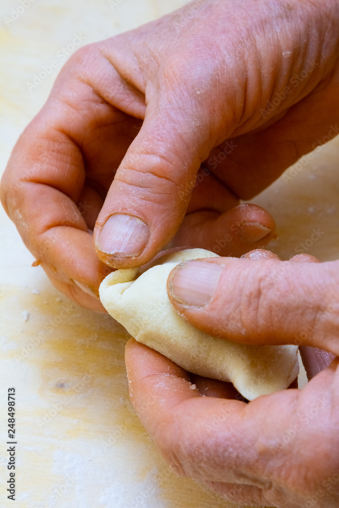 Grandmother cooks dumplings on kitchen Grandmother cooks dumplings on kitchen
