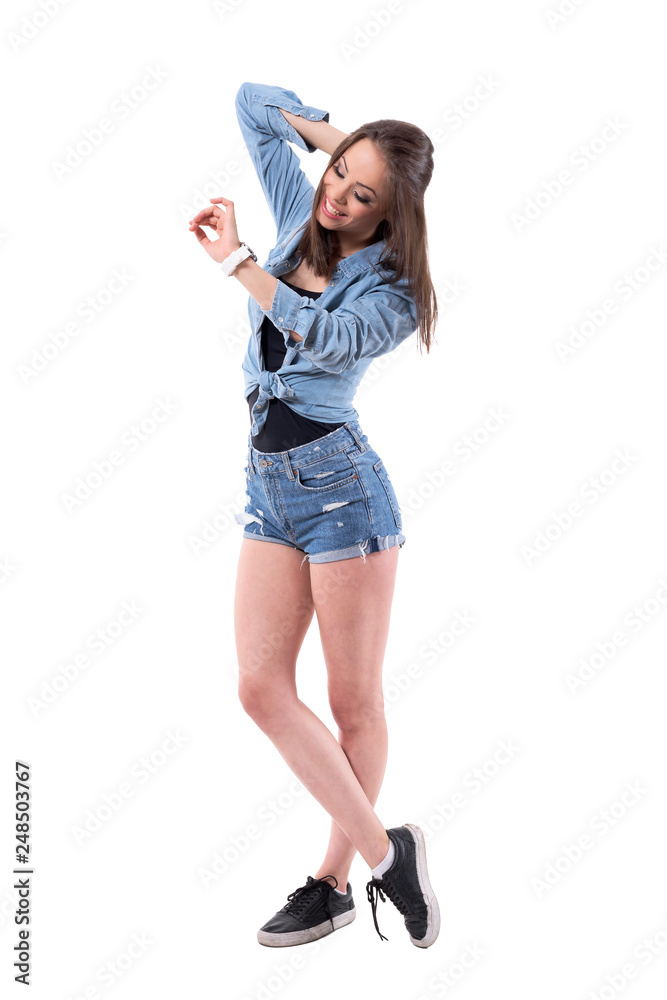 Carefree relaxed happy excited beautiful woman checking time on wrist watch. Full body isolated on white background. Carefree relaxed happy excited beautiful woman checking time on wrist watch. Full body isolated on white background.